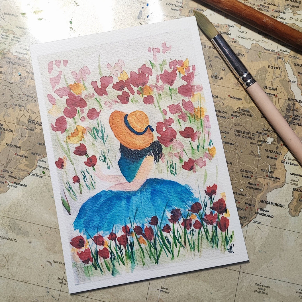 Carte illustrée à l'aquarelle une femme dans un champs de fleurs